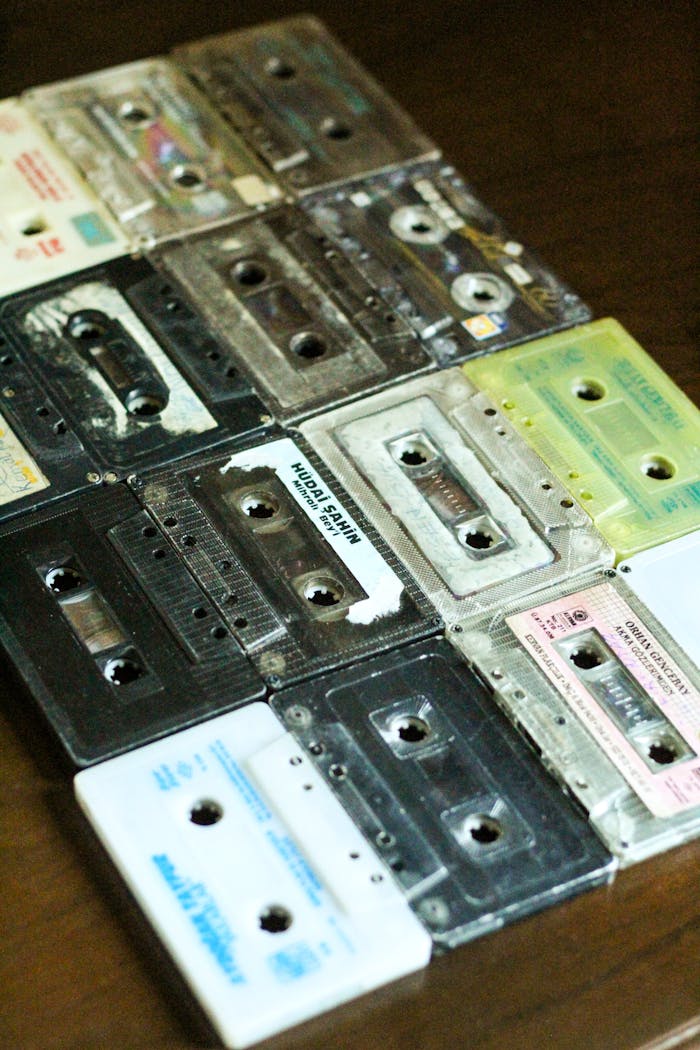 Close-up of retro cassette tapes arranged on a wooden surface, showcasing vintage style.